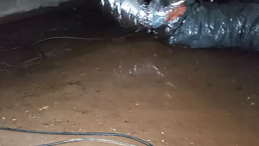 Damp dirt floor in an unsealed crawl space in Cherry Hill, NJ