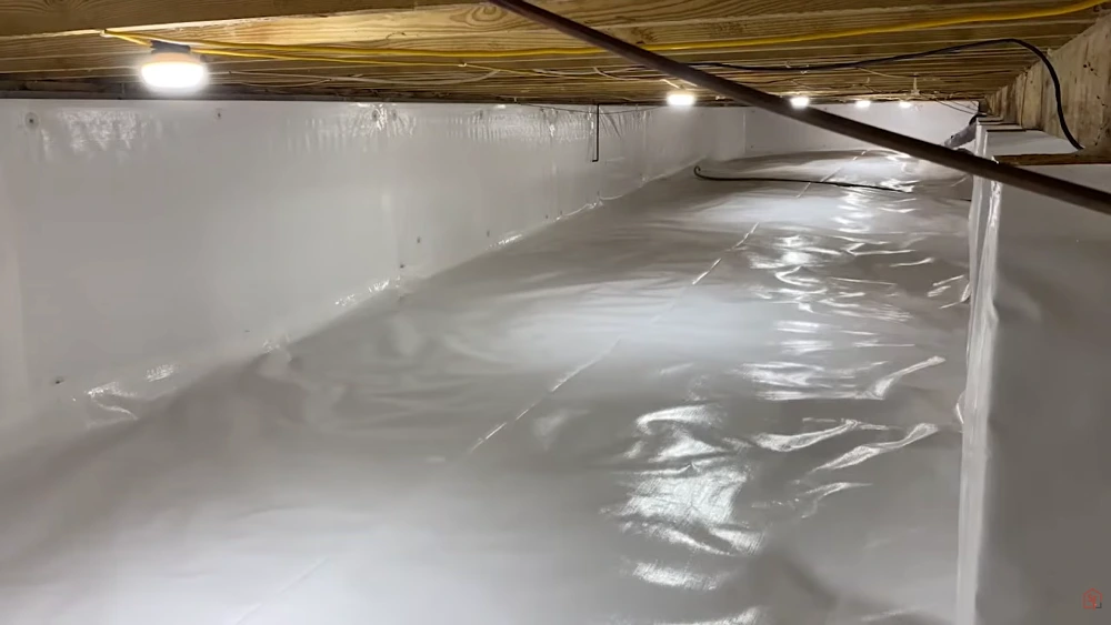 Fully encapsulated crawl space with sealed white vapor barrier after treatment in Cherry Hill, NJ